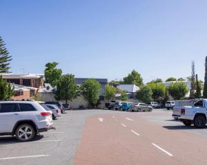 a parking lot with many cars parked in it at The Beaconsfield Hotel in Fremantle