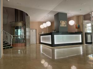 a large room with a lobby with a stair case at Bistra & Galina Hotel in Ruse