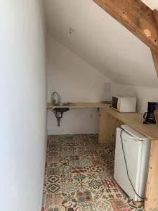 a kitchen with a white refrigerator and a counter at La Forge de Béduer in Béduer