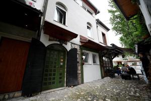 un edificio con una puerta verde en una calle en Apartments Magaza, en Sarajevo
