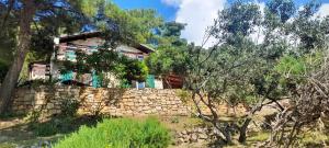 a house on top of a stone wall at Apartman Bonkovic in Gdinj