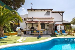 a house with a swimming pool in front of a house at Finca el Albero in Carratraca