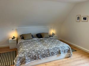 a bedroom with a large bed with two night stands at Gemütliche, ruhige Wohnung in Kindsbach