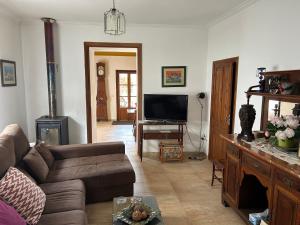 a living room with a couch and a flat screen tv at Casa Padrina Burballa in Maria de la Salut