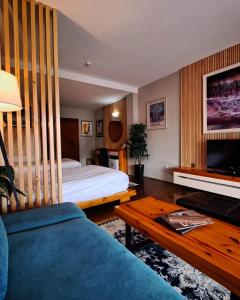 a hotel room with a bed and a couch at Aurora Resort & Spa in Berovo