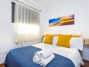 a bedroom with a bed with towels on it at Live Puertito Fragata with balcony in Puertito de Güímar