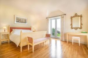 a bedroom with a bed and a table and a mirror at Country Setting in the Middle of Dingle Town. in Dingle