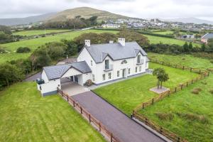 an aerial view of a white house on a green field at Country Setting in the Middle of Dingle Town. in Dingle