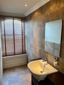 a bathroom with a sink and a mirror at The Dutch Mill Hotel in Aberdeen