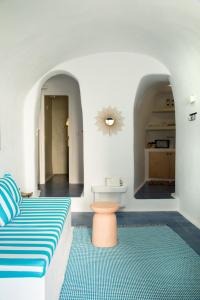 - un salon avec un canapé et un tapis dans l'établissement Amphora Villas Santorini Akrotiri, à Akrotiri