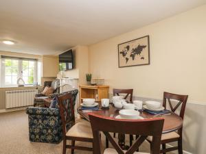 a kitchen and dining room with a table and chairs at Wharf Cottage in Lechlade