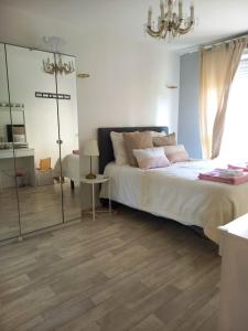 Un dormitorio con una cama grande y una lámpara de araña. en Appartement moderne et spacieux proche Paris, en Alfortville