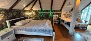 a bedroom with a bed and a desk in it at Cottage Kazka Lisu in Skhidnitsa