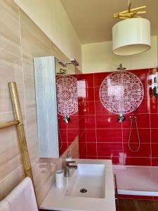 a bathroom with a sink and a red wall at Mirabel in Chieti