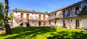 a large house with a lawn in front of it at Brzozowa Oaza in Mrzeżyno