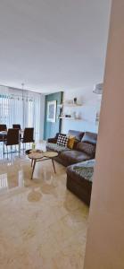 a living room with a couch and a table at Oasis en la cala a pasos de mar!! in Cala de Finestrat