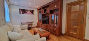 a living room with a couch and a tv at Family Apartment / Apartamento familiar Getxo in Getxo