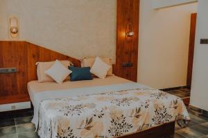 a bedroom with a bed with pillows on it at Willow House Vagamon in Vagamon