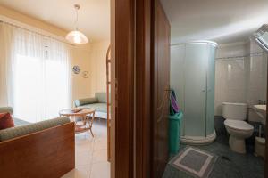 a bathroom with a shower and a toilet and a sink at Anastasia Sea View by RentalsPro Services - Nea Potidaia Halkidki in Nea Potidaea