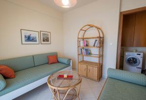 a living room with a couch and a table at Anastasia Sea View by RentalsPro Services - Nea Potidaia Halkidki in Nea Potidaea +41 photos