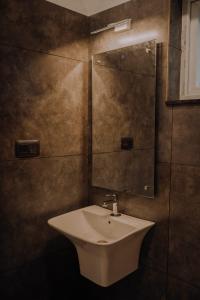 a bathroom with a sink and a mirror at Willow House Vagamon in Vagamon