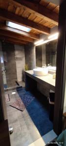 a bathroom with two sinks and a large mirror at Sea La Vie in Keramídhion
