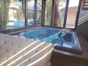 a jacuzzi tub in a room with windows at Residential Inn in Pretoria