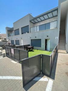a building with a fence in front of it at Galilee sea Sunset Suites in Migdal +2 photos