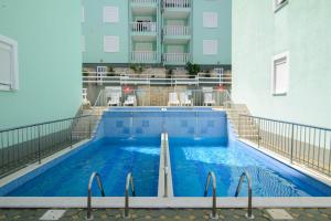 a swimming pool on a balcony of a building at Apartman Fishers View in Trogir