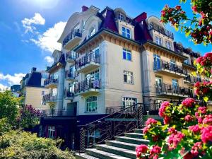 a large building with stairs in front of it at Sea Promenade Luxury Apartment in Świnoujście