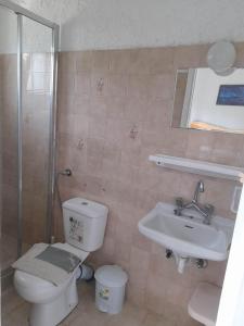 a bathroom with a toilet and a sink at Katafygio Die zuflucht in Marathias