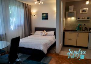 a small bedroom with a bed and a small kitchen at Apartment Sapphire Time in Łódź