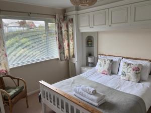 a bedroom with a bed with towels on it at Whitstable house with a view and 2 parking spaces in Kent
