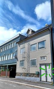 a building with green graffiti on the side of it at Tromso Coco Apartments in Center in Tromsø