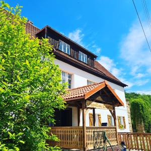 a house with a porch with a roof at Magnoliowy Zakątek in Idzików