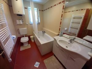 a bathroom with a sink and a toilet and a tub at Apartmani Dijana in Rab +40 photos