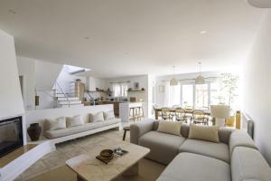 a living room with a couch and a table at Casa Almargens in Aljezur by Lisbeyond in Bordeira