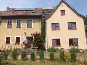 a man standing on a fence in front of a house at Radler Pension Wettin in Wettin