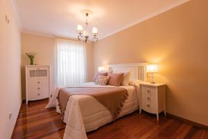 A bed or beds in a room at Casa Bértolo