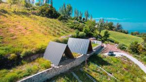 an aerial view of a house on a hill at Tlos Nature Houses in Yaka