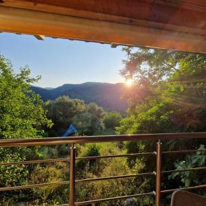 a view of the mountains from the porch of a cabin at Harcons Home in Katouna