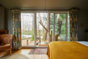 a bedroom with a bed and a large window at Victorian House in Grasmere