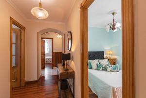 A bed or beds in a room at Casa Bértolo