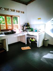 a kitchen with a sink and a counter top at Bara Village Guest House Bira in Bira