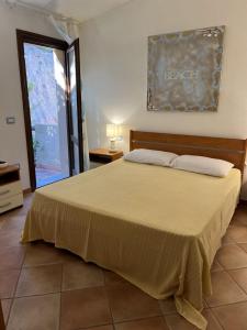 a bedroom with a large bed and a window at Costa Paradiso House in Li Valcaggi