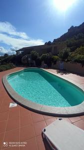 a large swimming pool on top of a house at Costa Paradiso House in Li Valcaggi