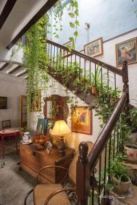 a living room with a spiral staircase with plants at Posada Maruja in Liétor