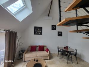 a living room with a couch and a table at Le gîte Chez Lucie in Le Liège