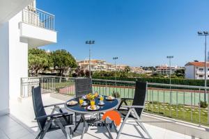 a table and chairs on the balcony of a apartment at #107 T1 Vista das Ondas by Home Holidays in Olhos de Água