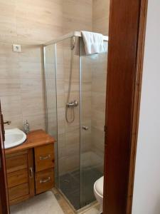 a bathroom with a shower and a toilet and a sink at Ubá Budo Praia - Villa in São Tomé